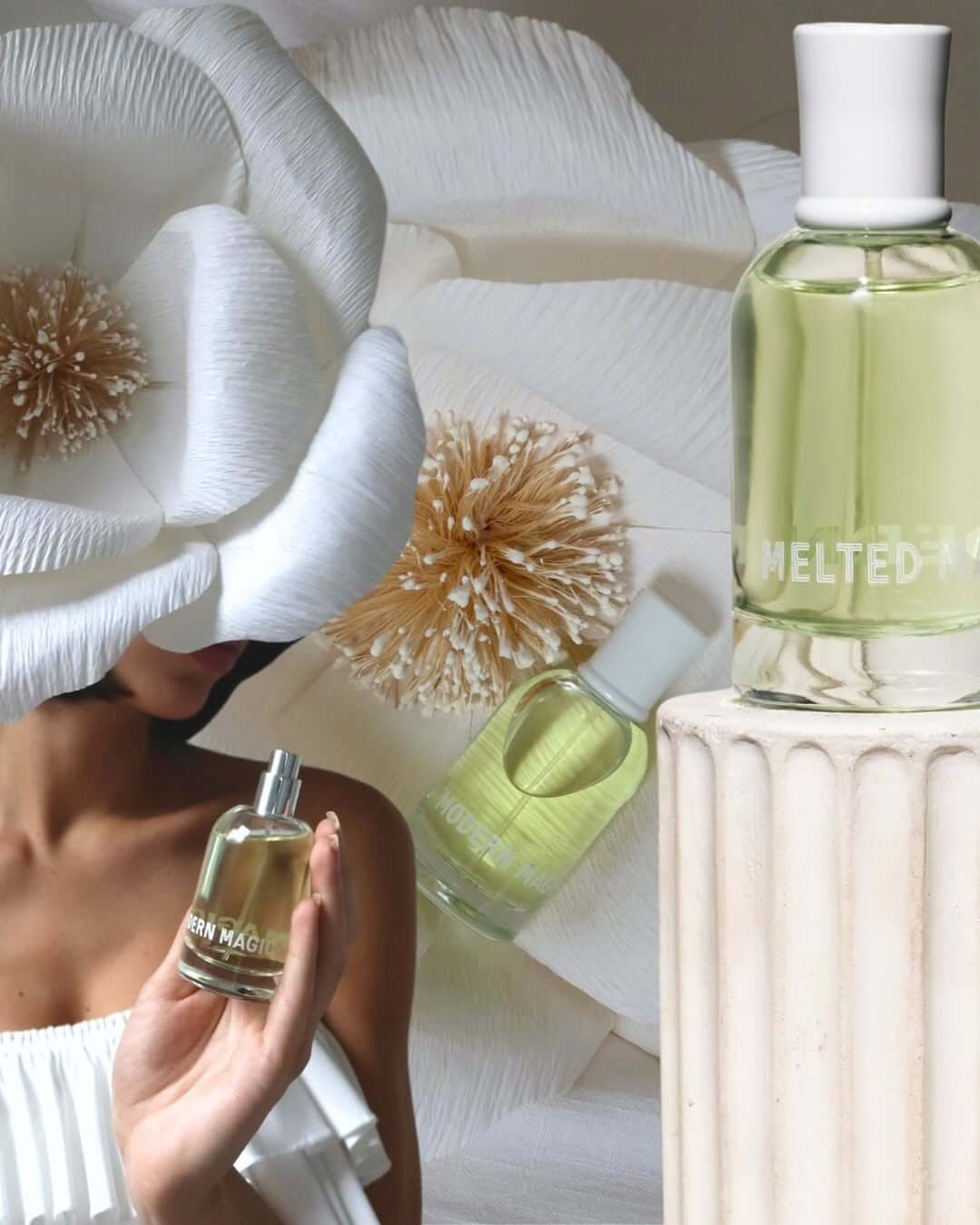 Woman holding Melted Magic Eau de Parfum with a floral background.